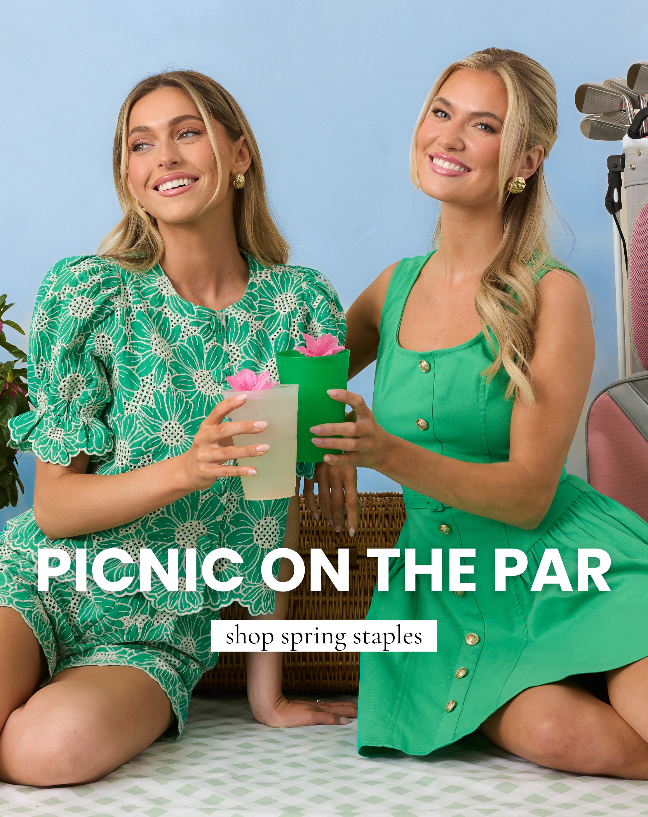 Two models wearing green spring dresses including a lace mini dress and a button front sleeveless dress styled with drinks and golf accessories for our Picnic On The Par collection. This image links to shop spring staples perfect for casual outings and golf tournament gatherings.