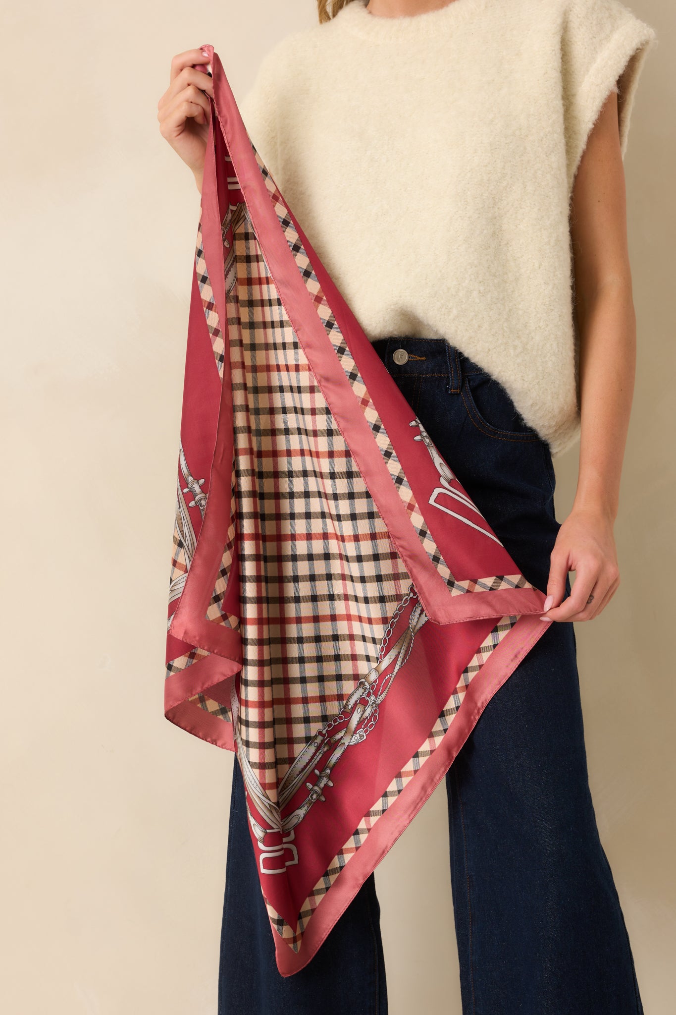 A back view of the square scarf highlighting its glossy satin finish, classic plaid design, and equestrian motif accents.