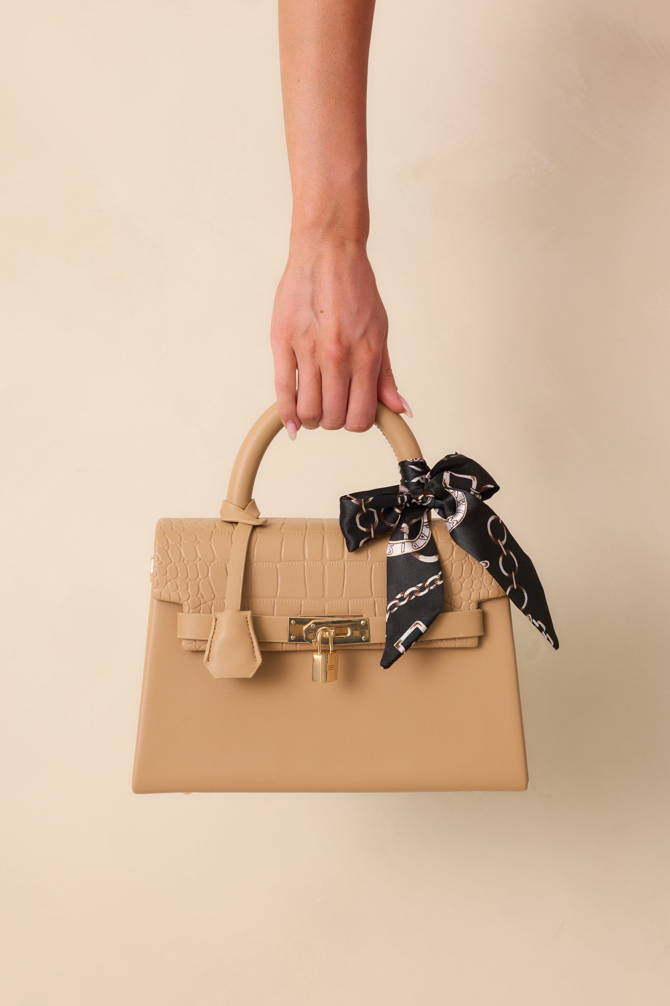 Full view of the structured tan handbag showcasing the removable faux croc leather flap and decorative self-tie scarf.