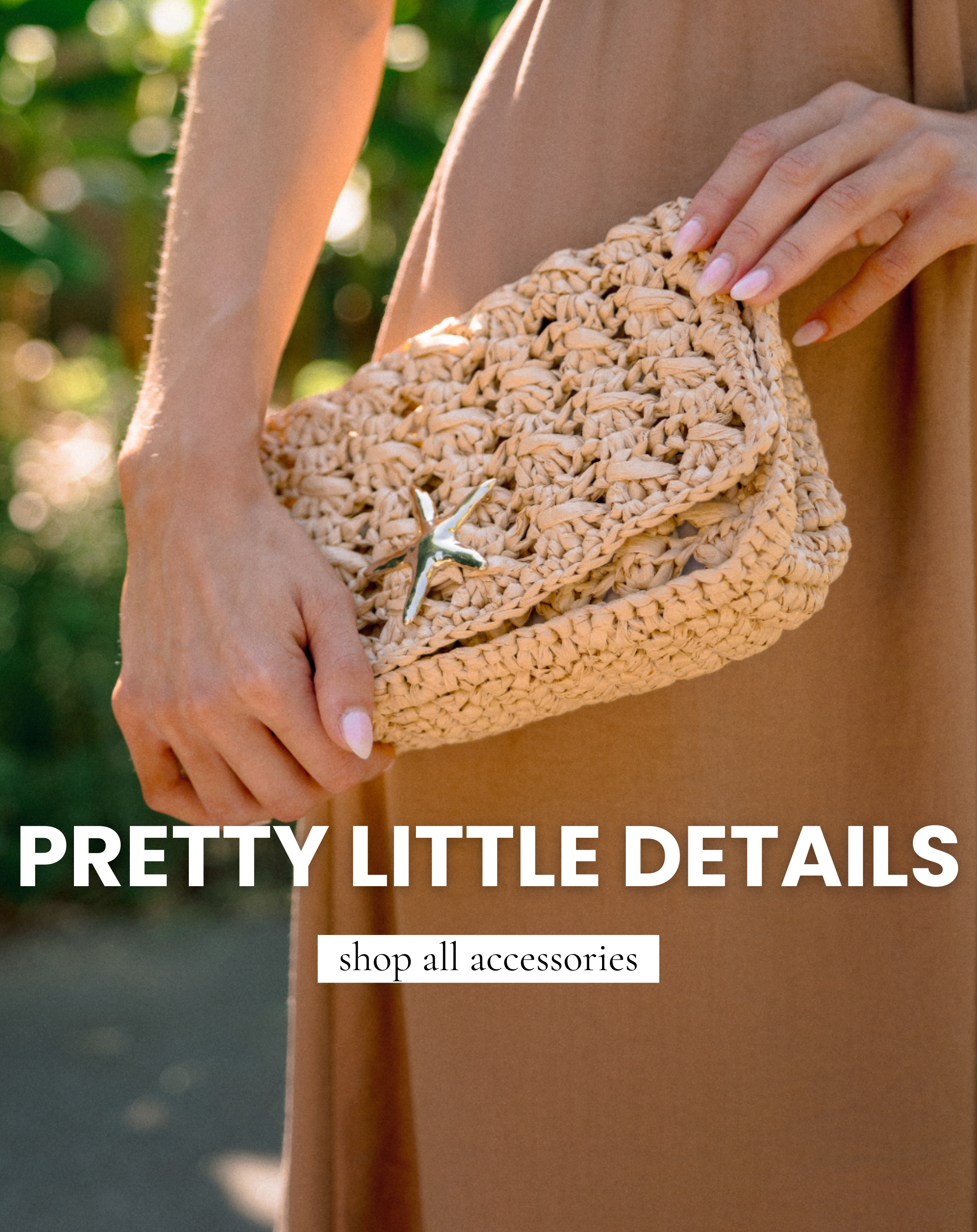 Woman holding a woven straw clutch purse with gold starfish detail styled with a neutral maxi dress in a tropical outdoor setting, promoting women’s fashion accessories.