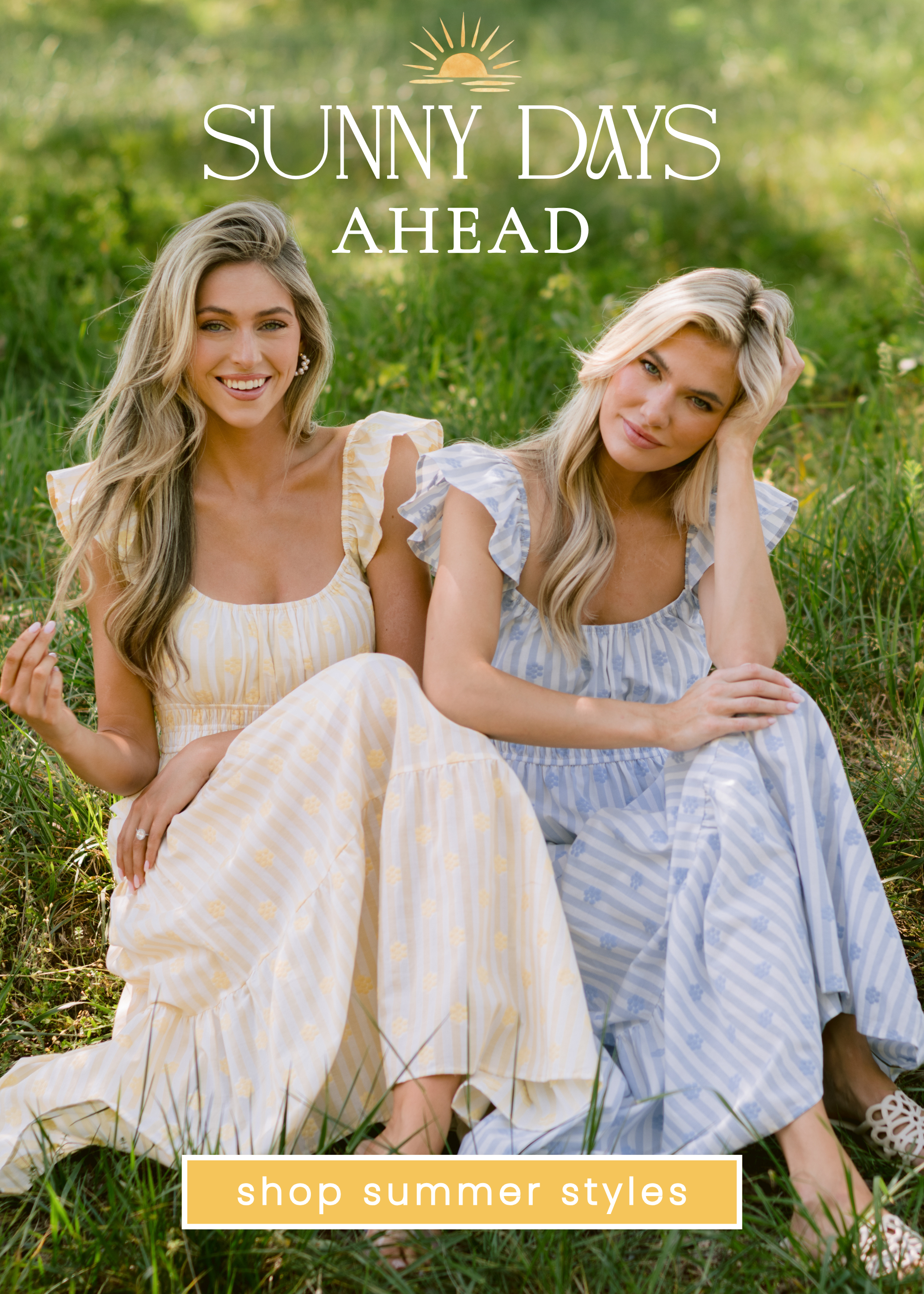 Two models sitting in a sunlit grassy field wearing soft pastel striped maxi dresses with flutter sleeves in yellow and blue. Text overlay reads “Sunny Days Ahead” with a sun graphic above and a button-style banner that says “shop summer styles.”