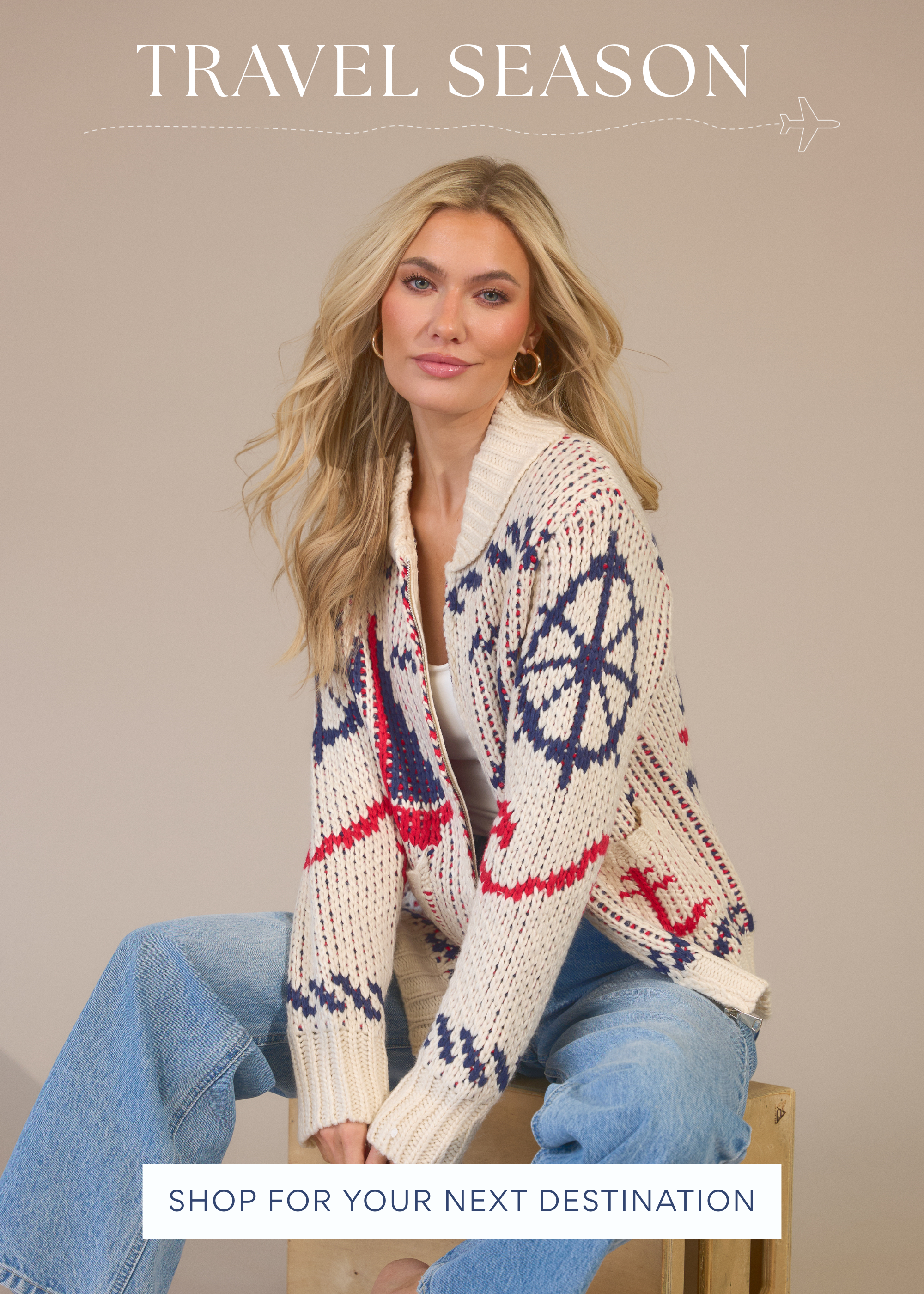 Model is wearing cream red and blue knit cardigan and jeans promoting Travel Season women’s clothing collection.