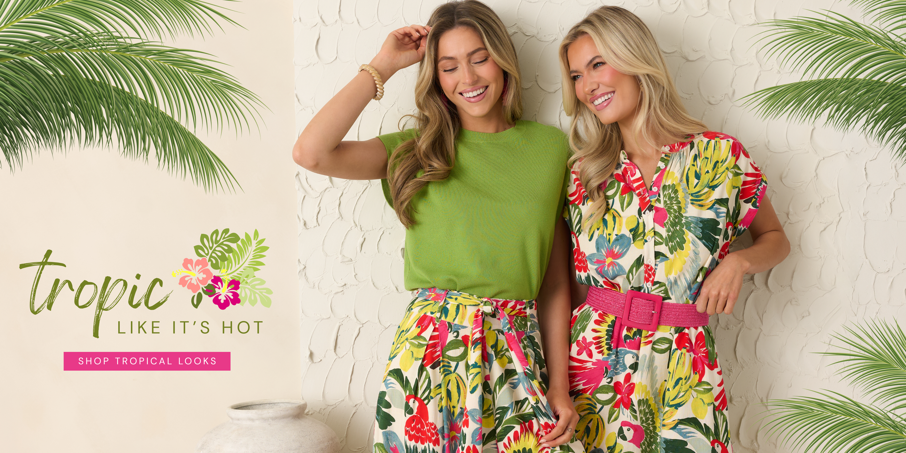 Two models wearing colorful tropical print outfits with bright floral patterns, styled for summer fashion. Looks featured in our Vacay Ready Collection.