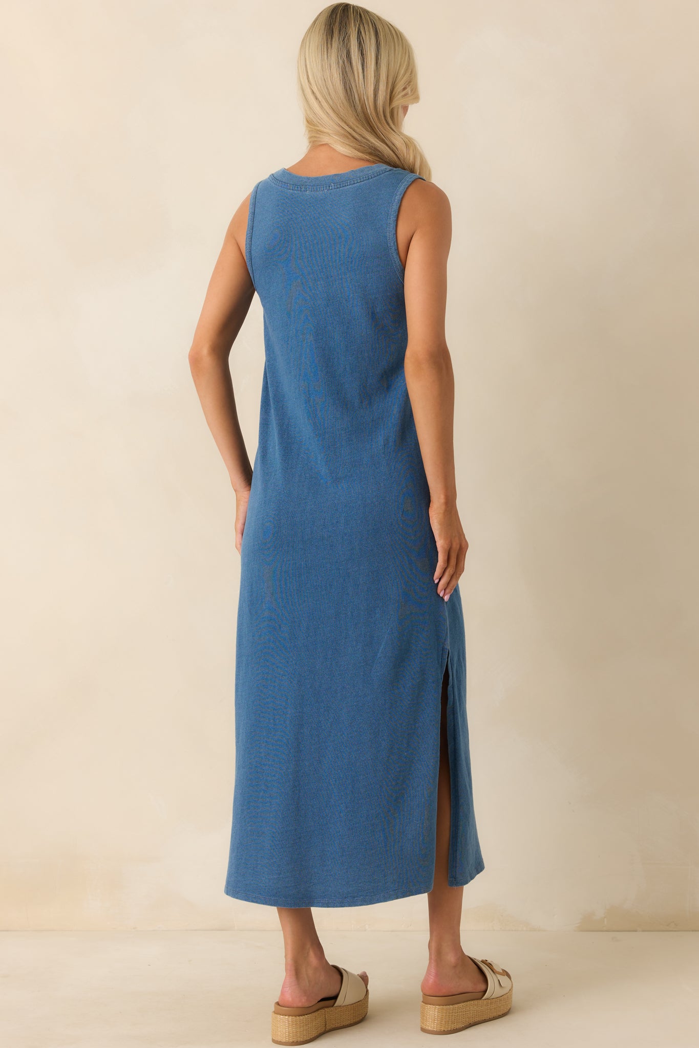 A back view of the midi dress displaying the sleeveless cut, relaxed fit, and subtle seam structure.