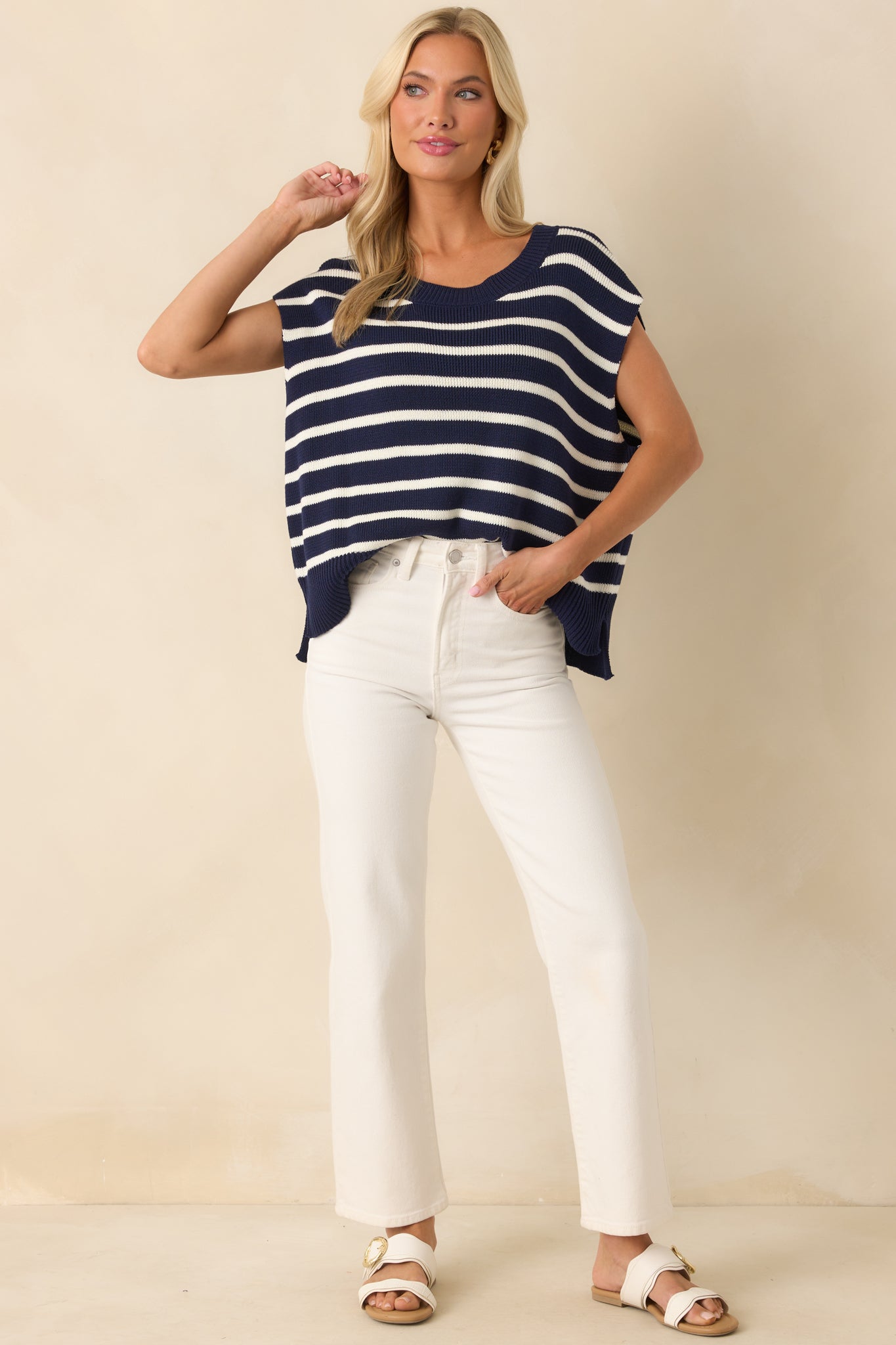 White high-waisted jeans with functional belt loops and button-zipper closure.