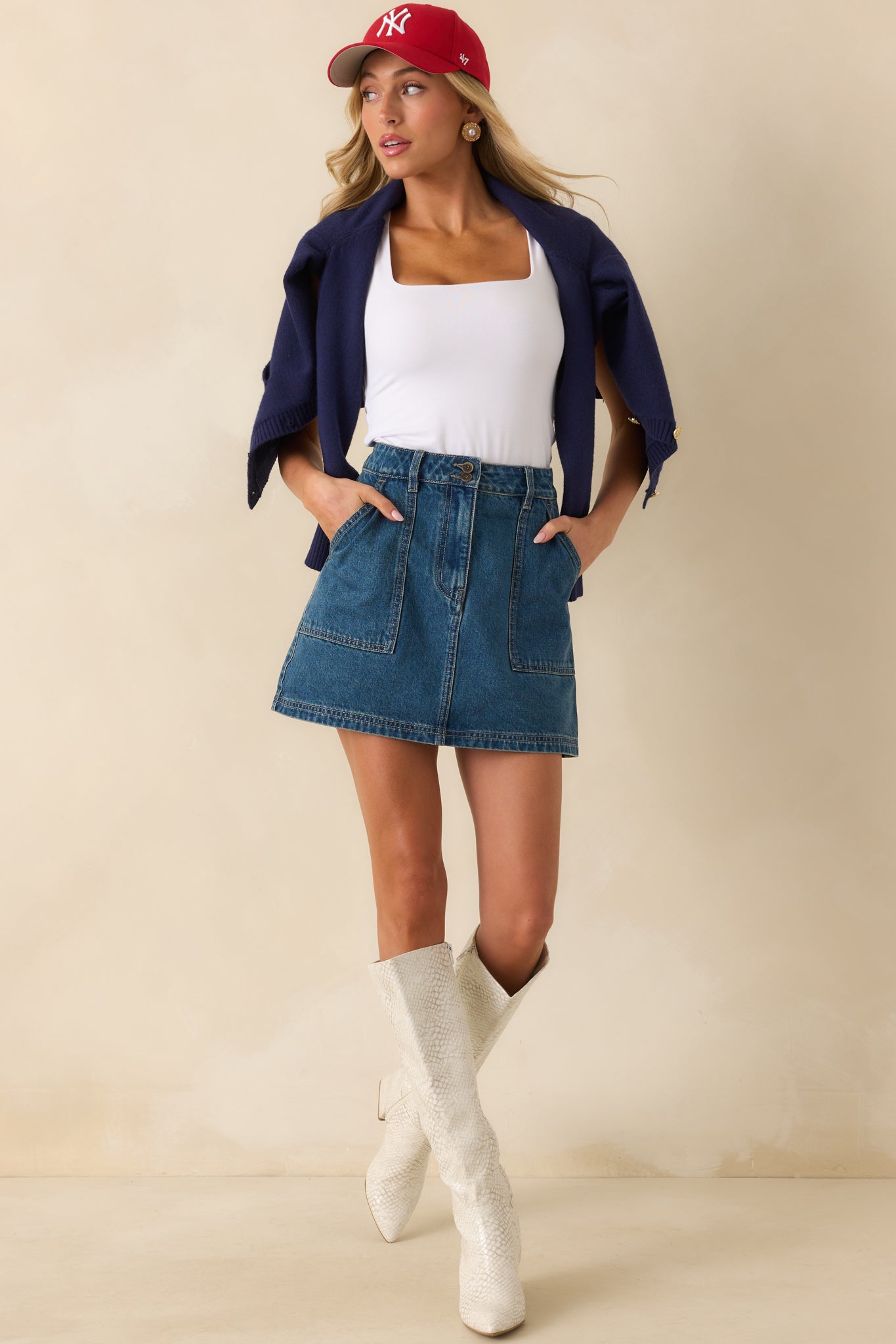 White knit tank top styled with wide straps and a sleek fitted shape for a minimalist look.