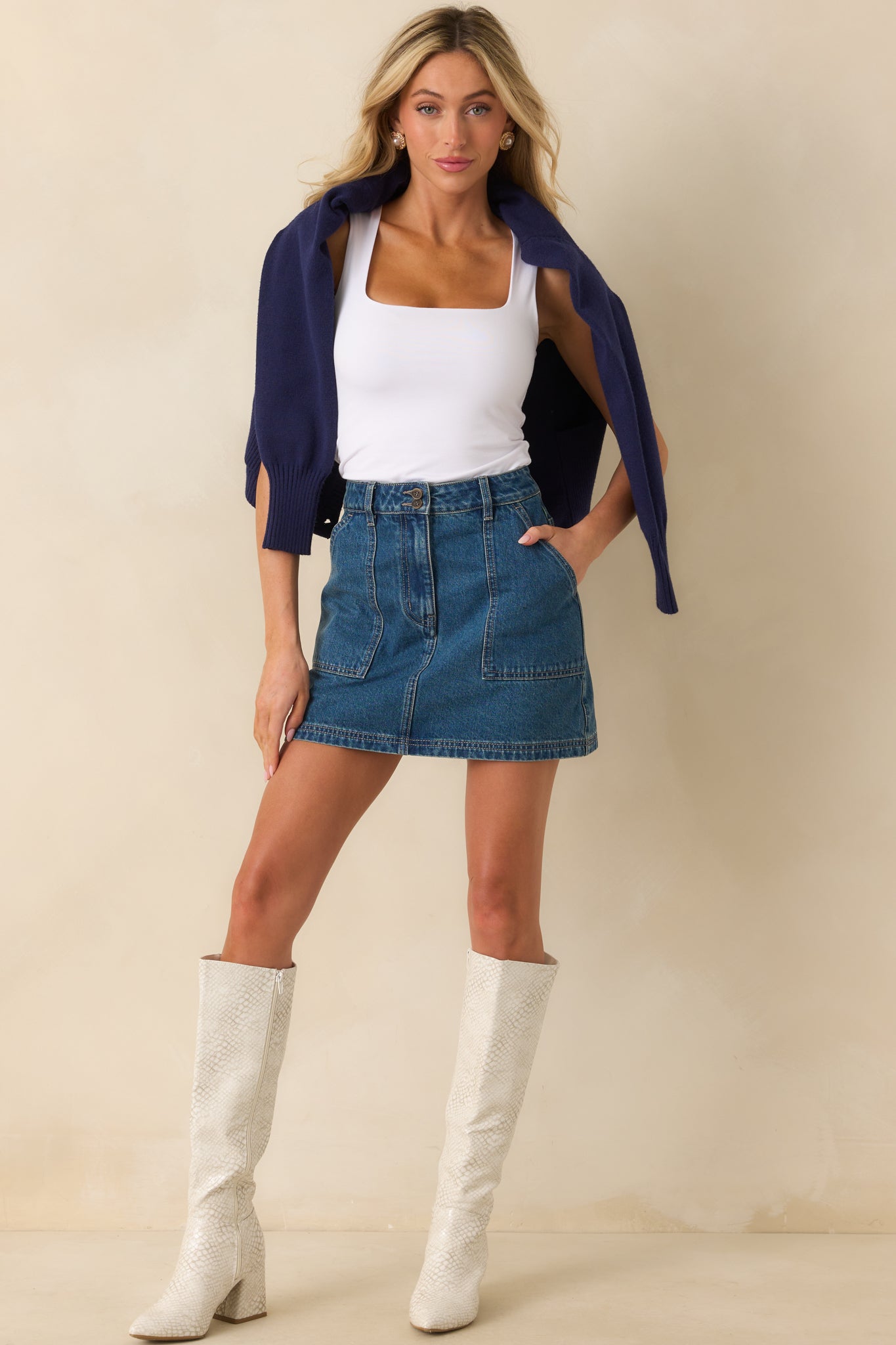 Front view of the white tank top featuring a fitted silhouette and straight hemline.