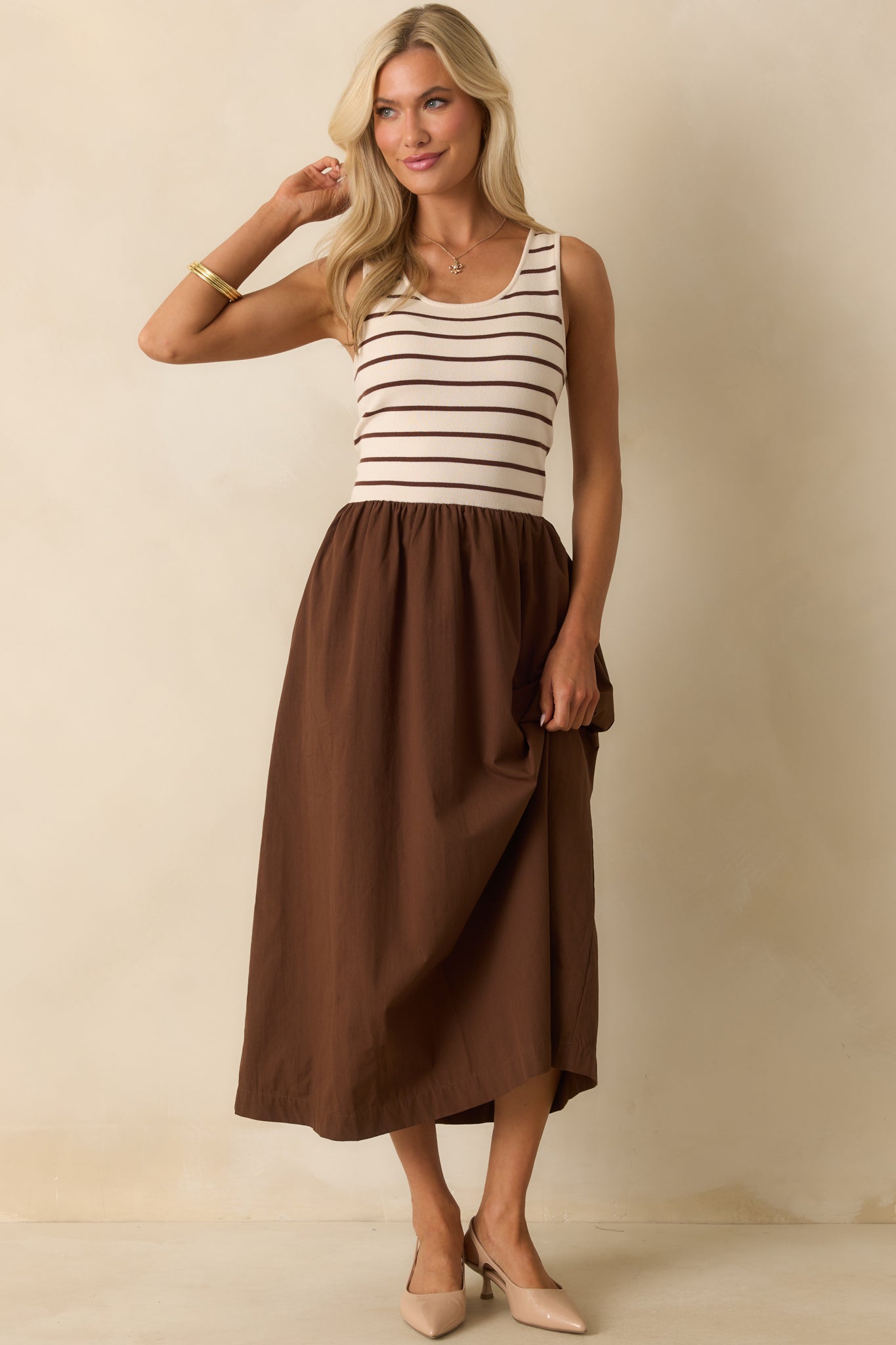 Wide tank straps and a gathered waist seam create a defined shape on the striped-and-solid dress.