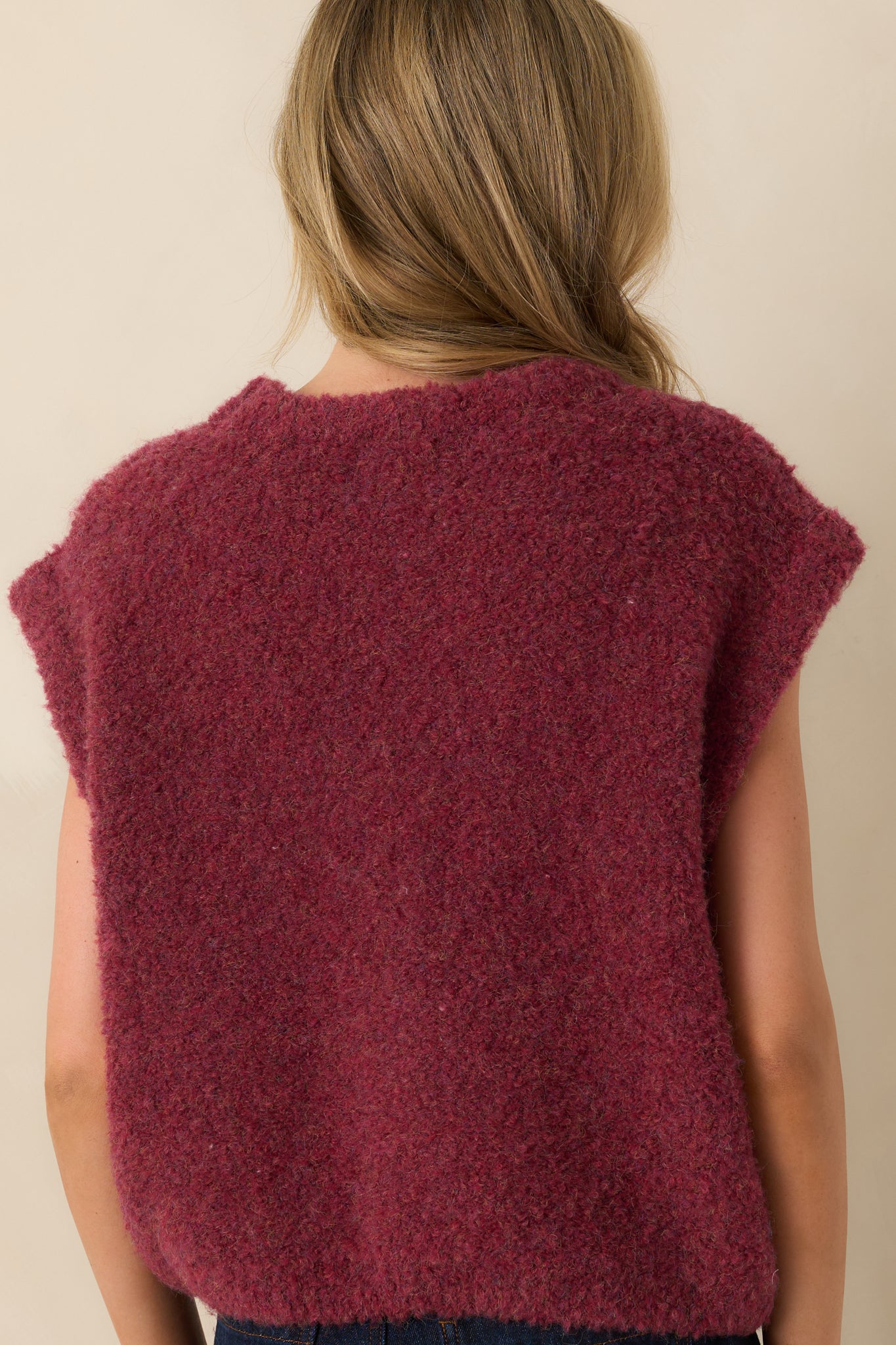 Rear view of the wine sweater vest showing the smooth knit fabric and sleeveless cut.