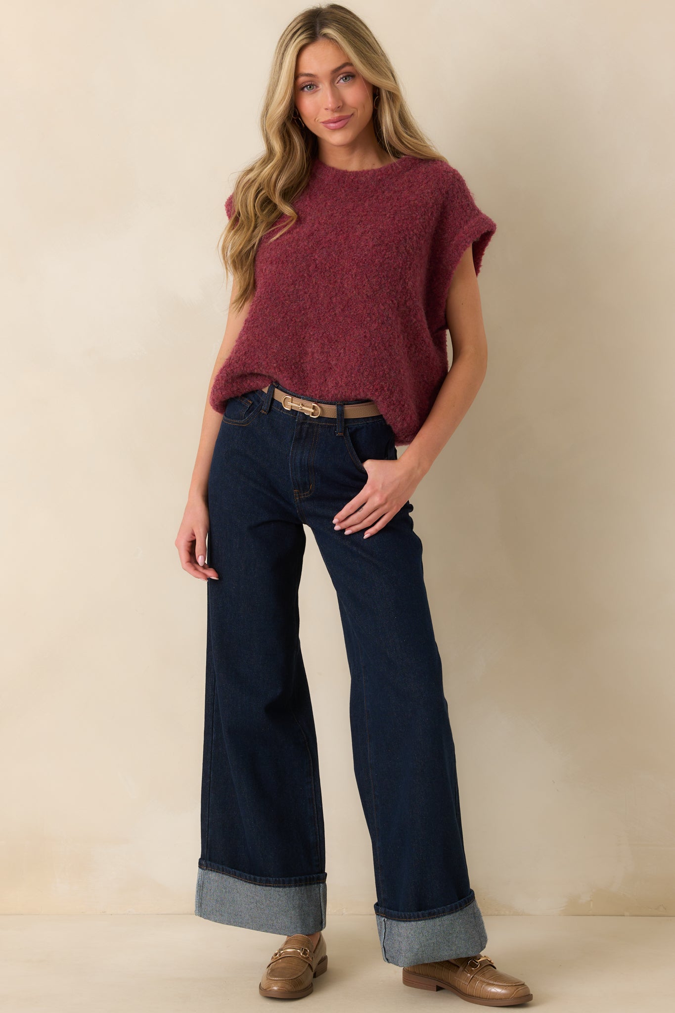 Wine-colored sweater vest with a crew neckline and oversized, sleeveless design.