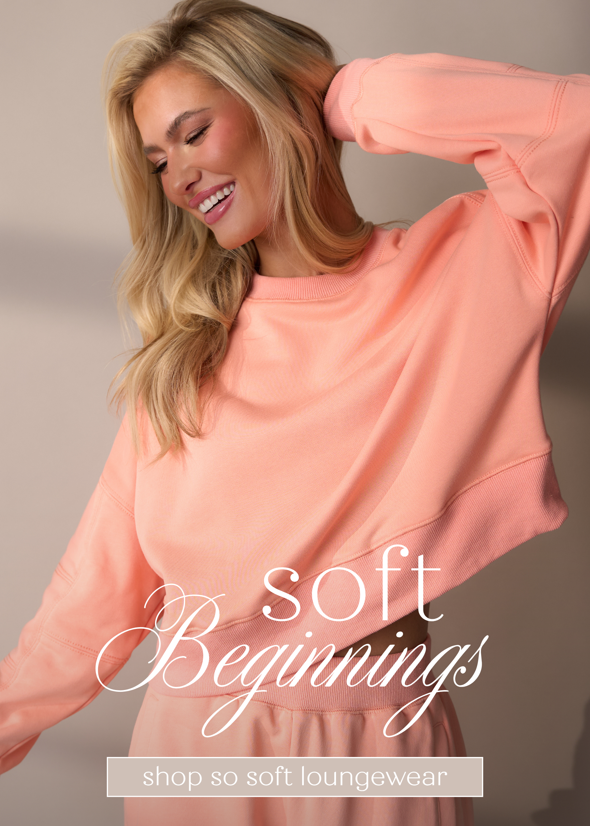 Model wearing a soft pink loungewear set featuring a cozy cropped sweatshirt, styled for a women’s loungewear collection.