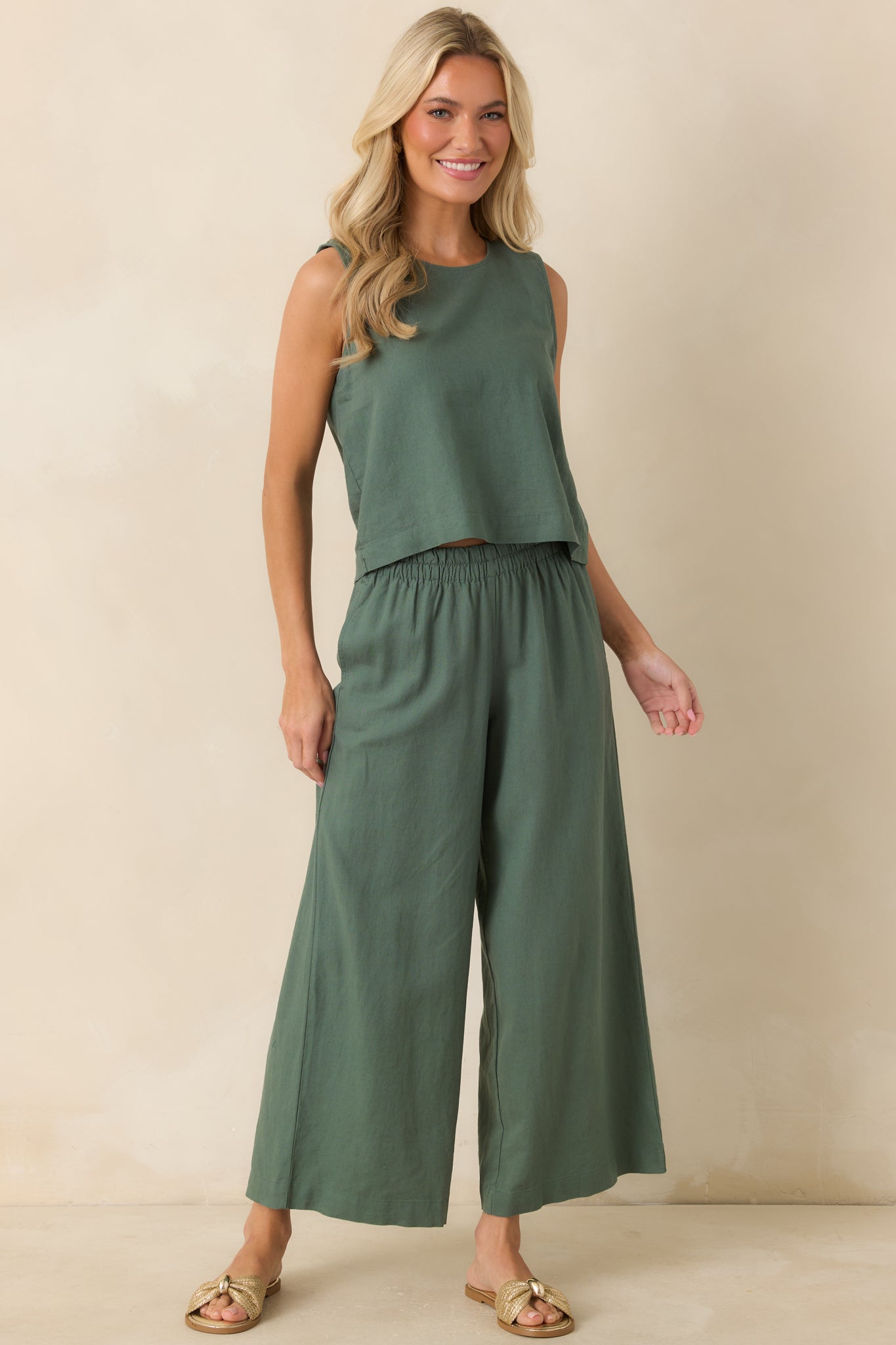 Everglade green cropped top with a boxy shape, soft linen blend texture, and classic crew neckline.