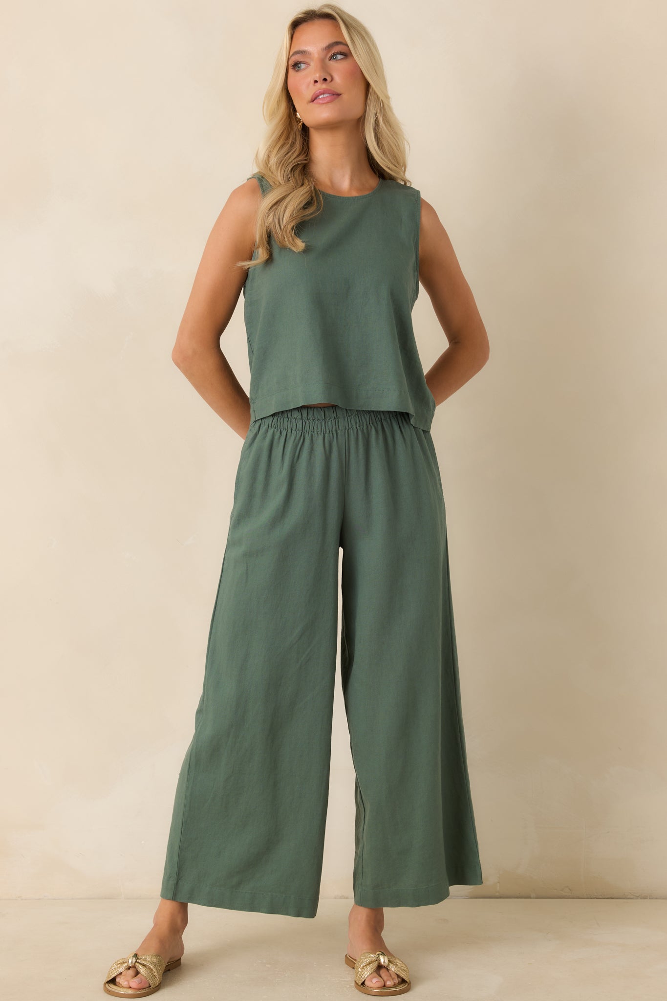 Green linen blend top featuring a comfortable relaxed silhouette, minimal design, and versatile cropped fit.