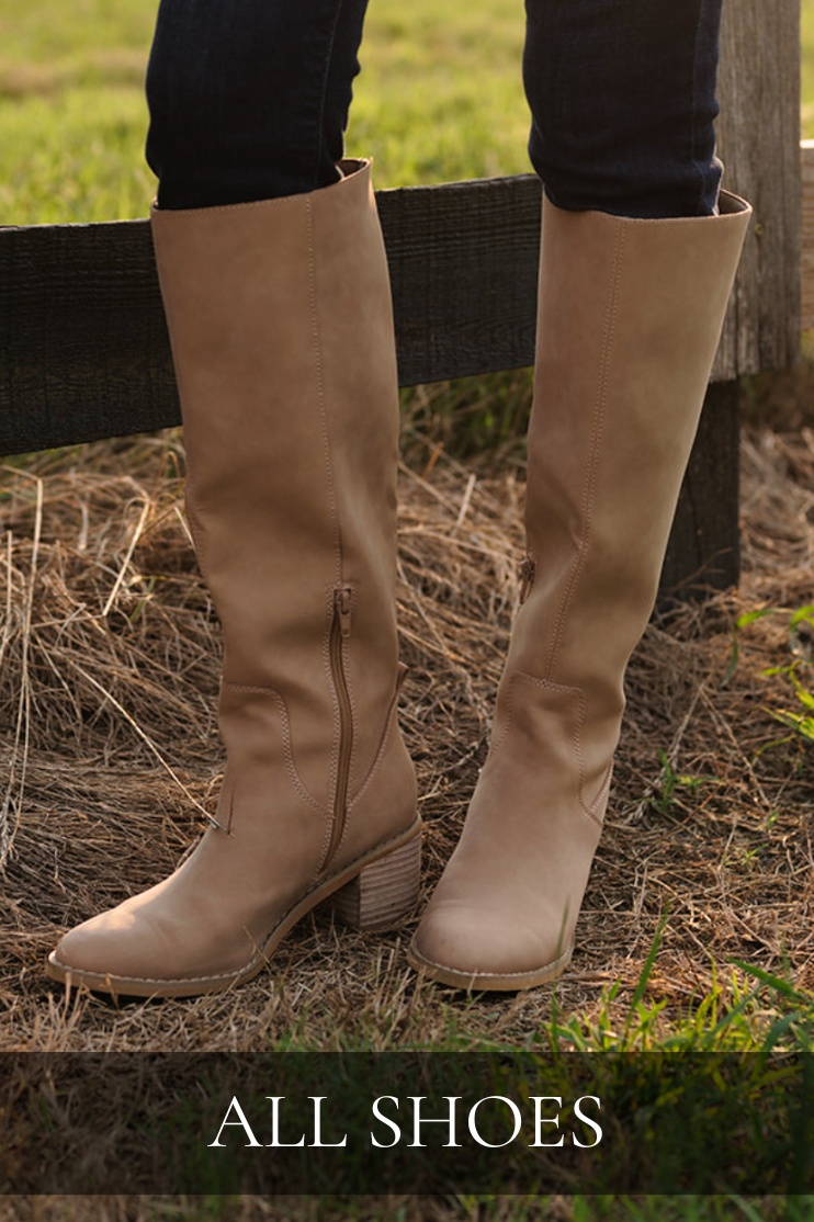 Tall taupe heeled boots styled with dark denim, featured in the All Shoes shop