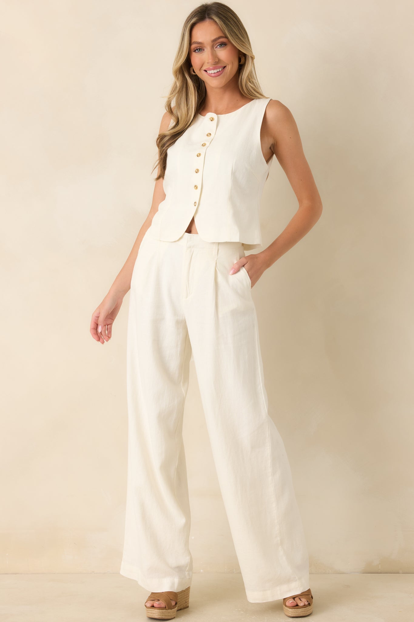 Ivory linen blend vest featuring a refined tailored silhouette, sleeveless design, rounded neckline, and classic button-front detailing.