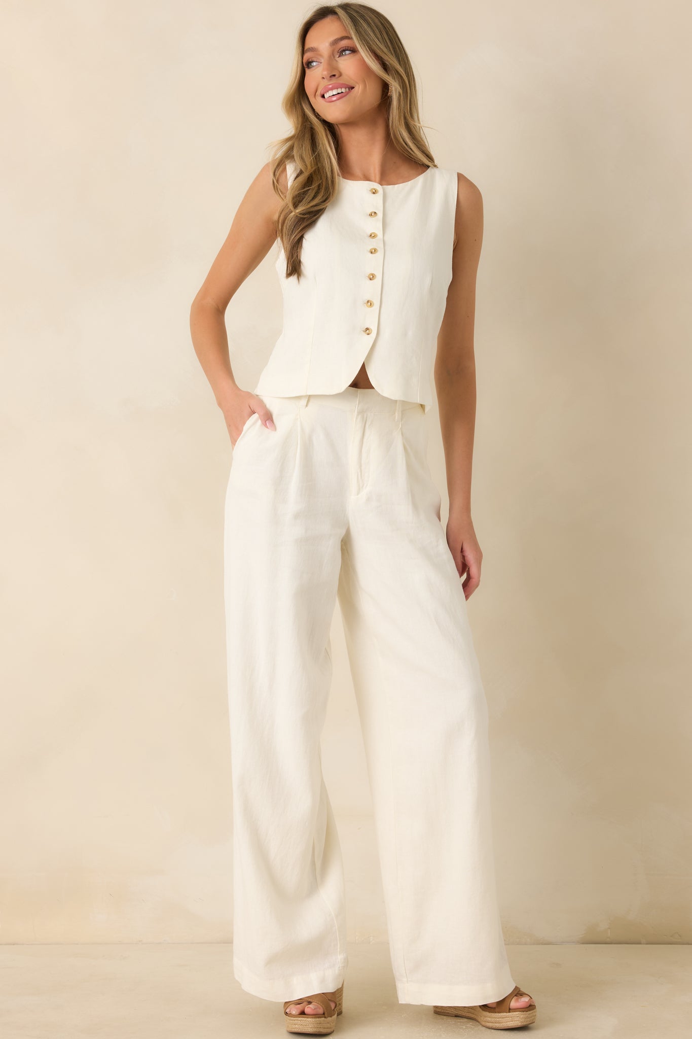 Lightweight ivory vest showcasing a slightly fitted silhouette, button-front closure, and versatile neutral linen blend fabric.