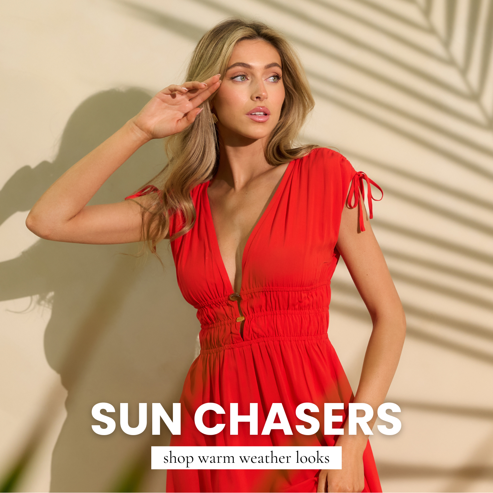 Model wearing a red sleeveless dress styled for vacation, featured in a women’s Sun Chasers vacation ready clothing collection.