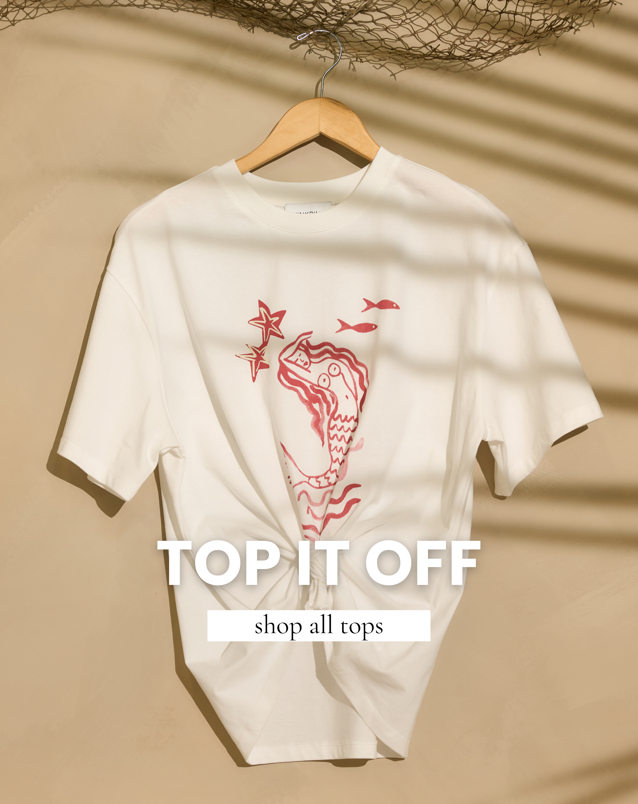 Women’s graphic tee top with coastal mermaid print featured in All Tops Shop.
