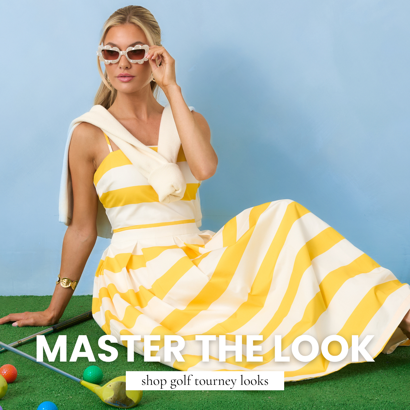 Model wearing a yellow and white striped midi dress with sunglasses, styled for a chic golf-inspired outfit.