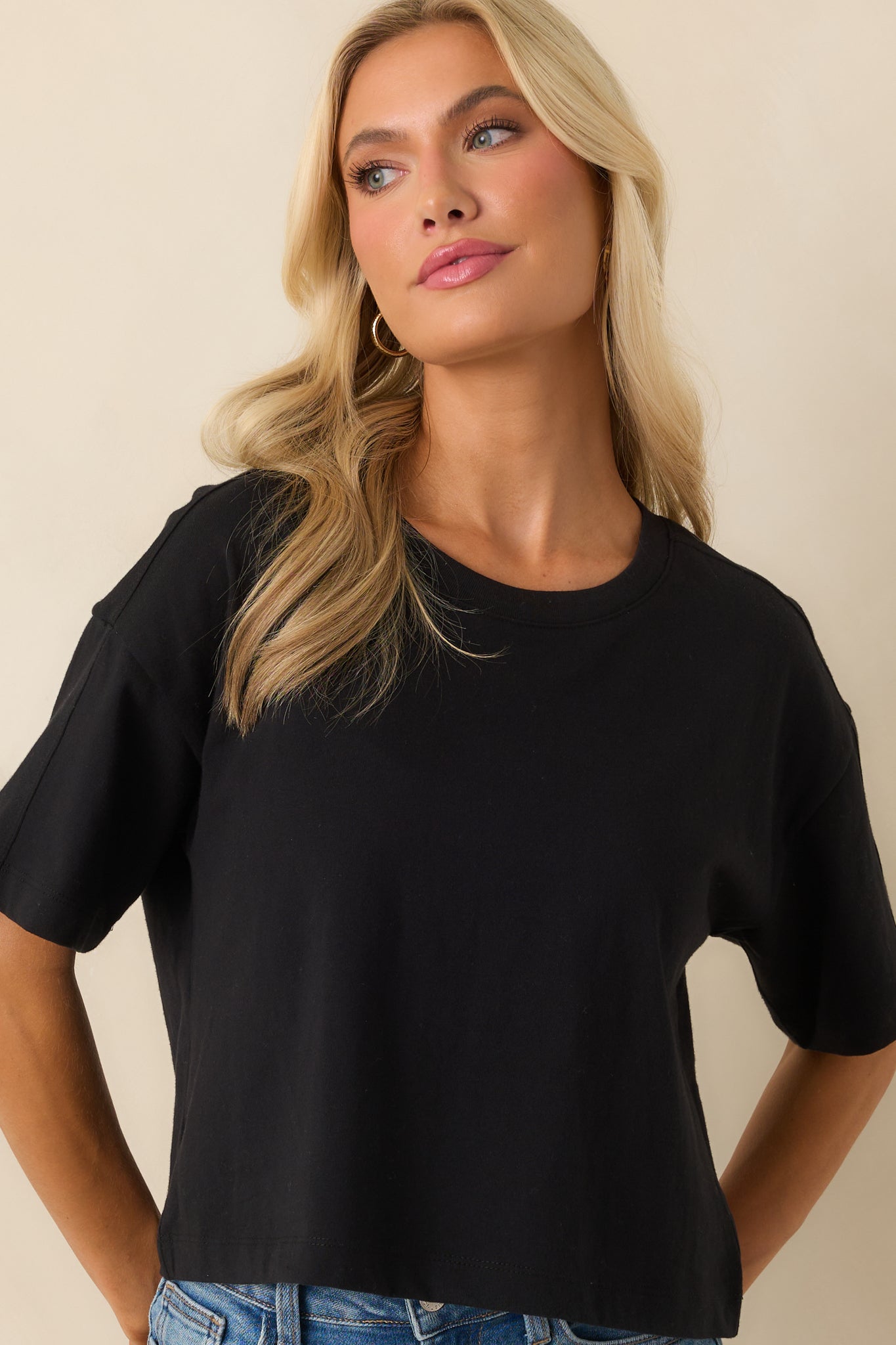 Cropped front detail showing the smooth lightweight cotton fabric and neckline seam.