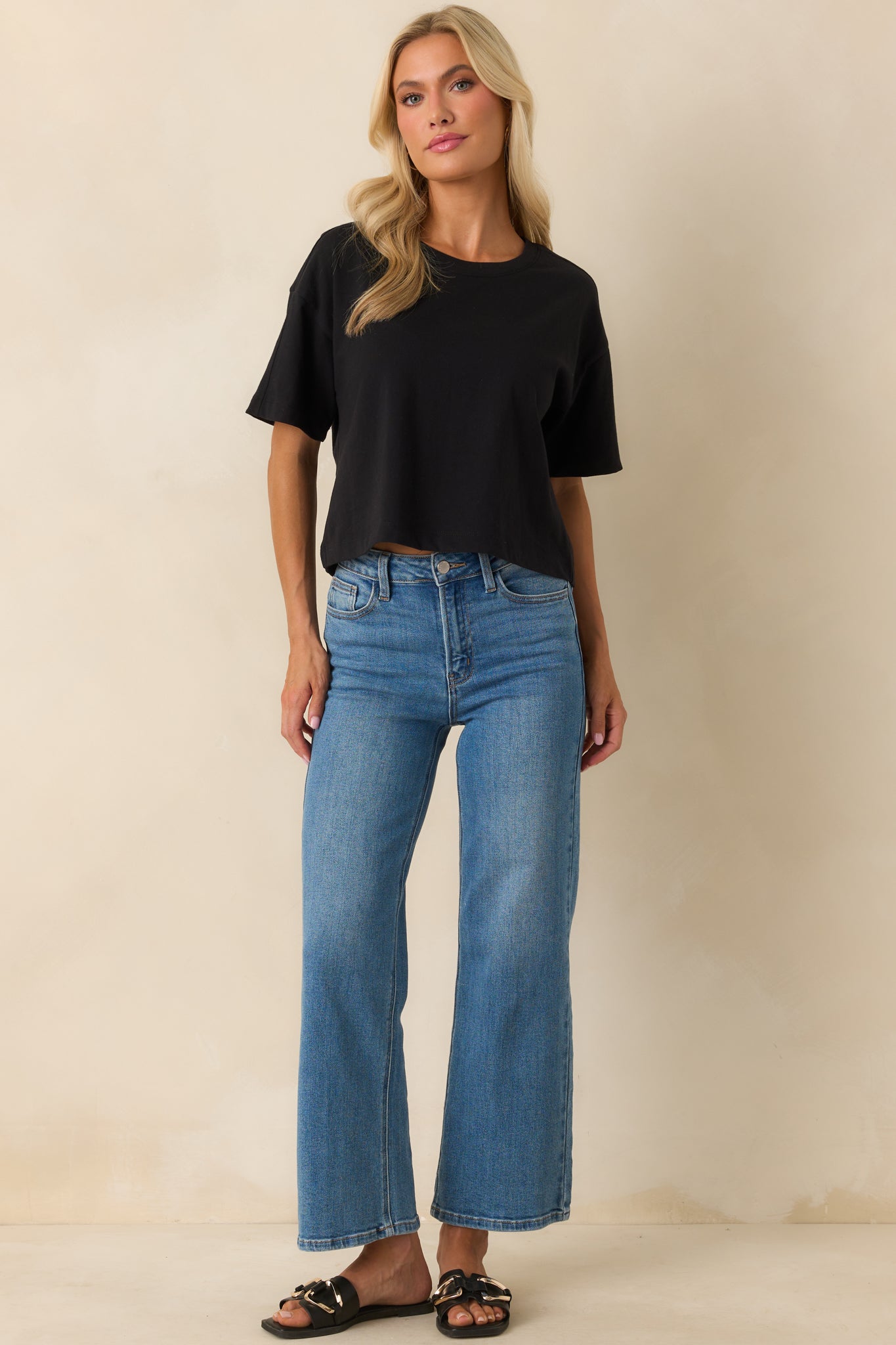 Front-facing black cotton tee highlighting its slightly cropped length and casual silhouette.