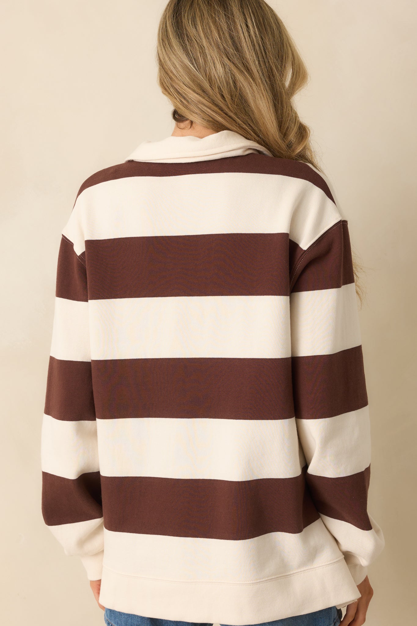 A view from behind of the pullover showing the drop shoulder design and striped pattern.
