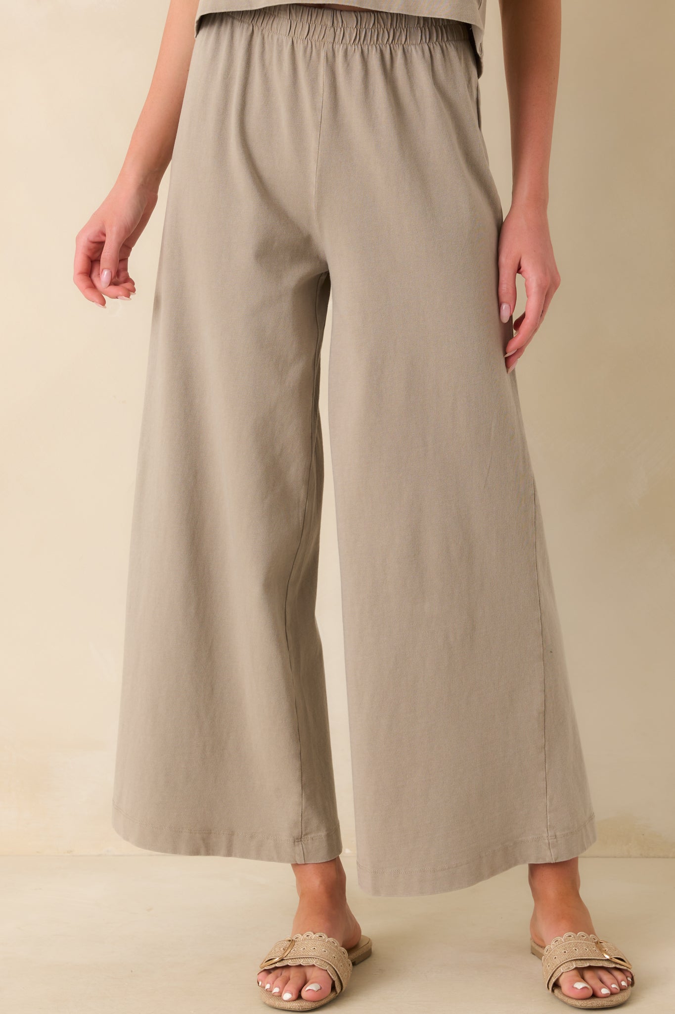 A cropped image of the lower pant legs showing the wide cut and fluid movement of the fabric.