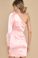 Back view of this dress that features an asymmetrical one shoulder neckline, an adjustable self-tie at the waist, and a satin-like material.