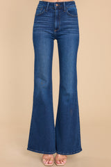 Front view of these jeans that feature a high waist, belt loops, front and back pockets, and a hemmed and flared bottom.