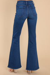 Back view of these jeans that feature a high waist, belt loops, front and back pockets, and a hemmed and flared bottom.