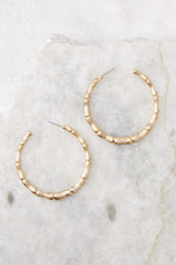 Top view of these hoops that feature texture detailing and a standard post-back closure.