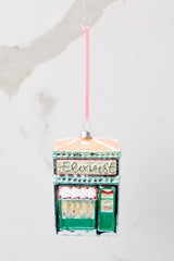 Front view of this ornament that features a florest shop that says 