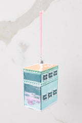 Back view of this ornament that features a florest shop that says 