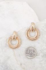 Gold encrusted dangle hoop earrings compared to quarter for actual size. Earrings measure 1.25