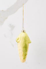 Back view of this ornament that features a design of corn with green glitter detailing on the ends.
