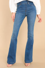 Front view of these jeans that feature a high waist, functional belt loops, and a flared leg.
