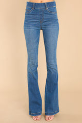 These indigo jeans feature a high waist, functional belt loops, slip on design, and a flared leg.