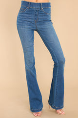Front view of these jeans that feature a high waist, functional belt loops, slip on design, and a flared leg.