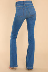 Back view of these jeans that feature a high waist, functional belt loops, slip on design, and a flared leg.