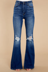 Front view of these jeans that feature light distressing throughout, wide legs, and functional pockets.