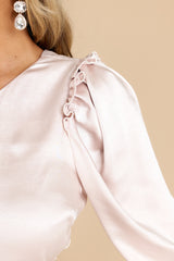 Close up view of this dress that features an asymmetrical one shoulder neckline.