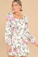 Front view of  this dress that features a floral pattern throughout. 
