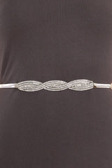 Close up view of this belt that features a rhinestone buckle with a hook and eye closures.