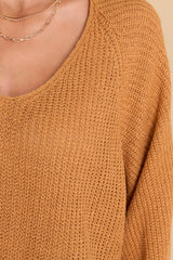Close up view of this sweater that features a subtle v-neckline, long sleeves with tapered cuffs, a bottom hem that is approximately 2