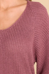 Close up view of this sweater that features a subtle v-neckline, long sleeves with tapered cuffs, a bottom hem that is approximately 2