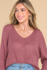 Front view of this sweater that features a subtle v-neckline, long sleeves with tapered cuffs, a bottom hem that is approximately 2