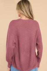 Back view of this sweater that features a subtle v-neckline, long sleeves with tapered cuffs, a bottom hem that is approximately 2