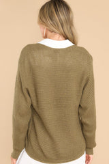 Back view of  this sweater that features a subtle v-neckline, long sleeves with tapered cuffs, a bottom hem that is approximately 2