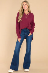 Full body view of this sweater that features a round neckline with four button closures and long sleeves with tapered cuffs.