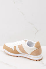 Inside view of tan sneaker with leather detailing on the back of the heels. 
